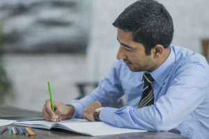 Image:  Professional man with green pencil coloring